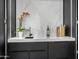 Stylish wet bar boasts a sleek black countertop, a marble backsplash, and modern accents at 8038 E Clarendon Ave, Scottsdale, AZ 85251