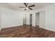 Bright bedroom with dark wooden floors, ceiling fan and closet at 8315 E Vernon Ave, Scottsdale, AZ 85257