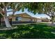 Inviting single-story house featuring lush green lawn, mature trees, and a well-maintained exterior at 8315 E Vernon Ave, Scottsdale, AZ 85257