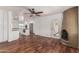 Open floorplan featuring wood flooring and a unique fireplace with a view to the modern kitchen at 8315 E Vernon Ave, Scottsdale, AZ 85257