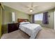 Bedroom with queen bed, carpet, and ceiling fan at 8532 E Sheridan St, Scottsdale, AZ 85257