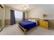 Bedroom featuring a double bed, carpet, and a wooden headboard at 8532 E Sheridan St, Scottsdale, AZ 85257