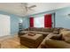 Bright living room with a large sectional sofa, a ceiling fan, and natural light from a window at 8532 E Sheridan St, Scottsdale, AZ 85257