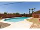 A refreshing backyard pool with a well-maintained deck and mature palm trees for a relaxing outdoor experience at 8532 E Sheridan St, Scottsdale, AZ 85257
