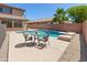 Backyard features a pool with a seating area and patio at 9051 W Iona Way, Peoria, AZ 85383