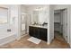 Bright bathroom features double sinks, granite counters, and tub with glass door at 9051 W Iona Way, Peoria, AZ 85383