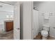 This bathroom includes a toilet, towel rack, and a shower with a white shower curtain at 9051 W Iona Way, Peoria, AZ 85383