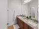 Bright bathroom features double sinks with granite counters, white cabinets, and modern fixtures at 9051 W Iona Way, Peoria, AZ 85383