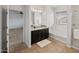 Bright bathroom features double sinks, granite counters, and tub with shower combination at 9051 W Iona Way, Peoria, AZ 85383