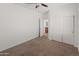 Inviting bedroom offers plush carpeting, a ceiling fan, and convenient access to closet space at 9051 W Iona Way, Peoria, AZ 85383