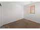 Cozy bedroom featuring neutral carpet, blinds, and simple electrical fixtures at 9051 W Iona Way, Peoria, AZ 85383