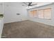 Large bedroom with a ceiling fan, plush carpet, and well-lit with natural light at 9051 W Iona Way, Peoria, AZ 85383