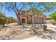 Charming two-story home with a well-manicured front yard, mature trees, and attached two car garage at 9051 W Iona Way, Peoria, AZ 85383