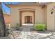 Inviting home exterior with a covered entryway, low-maintenance landscaping, and a warm, neutral color palette at 9051 W Iona Way, Peoria, AZ 85383