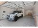 A clean, spacious garage with a white SUV, with room for parking and storage solutions at 9051 W Iona Way, Peoria, AZ 85383
