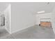 Empty garage featuring light colored walls, cement floors, and a water heater at 9051 W Iona Way, Peoria, AZ 85383