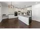 Modern kitchen with granite countertops, white cabinets, and stainless steel appliances at 9051 W Iona Way, Peoria, AZ 85383