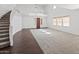 Spacious living area with hardwood trim, plush carpeting, and a staircase at 9051 W Iona Way, Peoria, AZ 85383
