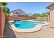 Backyard features a pristine pool with patio, and a view of the house at 9051 W Iona Way, Peoria, AZ 85383