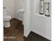 Stylish powder room with a pedestal sink and decorative hourglass accents at 9051 W Iona Way, Peoria, AZ 85383
