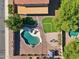 Expansive backyard featuring a pool, patio, artificial grass, and desert landscaping at 941 E Stirrup Ln, San Tan Valley, AZ 85143
