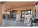 Spacious covered patio with seating, a grill, plants, and a view of the backyard at 941 E Stirrup Ln, San Tan Valley, AZ 85143