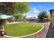 Spacious backyard with artificial turf, pavers, desert landscaping, storage shed, and a fenced pool at 941 E Stirrup Ln, San Tan Valley, AZ 85143