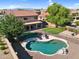 Private backyard oasis with a pool, covered patio, and lush landscaping at 941 E Stirrup Ln, San Tan Valley, AZ 85143