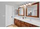 Bathroom featuring double sinks with dark wood cabinets and modern mirrors at 941 E Stirrup Ln, San Tan Valley, AZ 85143