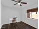 Neutral bedroom features a wood-look floor, window, and ceiling fan at 941 E Stirrup Ln, San Tan Valley, AZ 85143