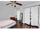 A bedroom features modern ceiling fan, a small dresser, and a closet with white curtains at 941 E Stirrup Ln, San Tan Valley, AZ 85143