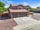 A two-story home boasts a spacious three-car garage and low-maintenance desert landscape at 941 E Stirrup Ln, San Tan Valley, AZ 85143