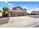 Two-story home featuring a three-car garage with a desert front yard and a welcoming curb appeal at 941 E Stirrup Ln, San Tan Valley, AZ 85143