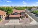 Aerial front view of a two-story home with a three-car garage, desert landscaping, and a tile roof at 941 E Stirrup Ln, San Tan Valley, AZ 85143