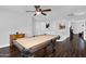 A game room featuring a pool table with wood floors and neutral walls offers a clean, bright space at 941 E Stirrup Ln, San Tan Valley, AZ 85143