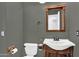 Charming half-bath with a pedestal sink and a decorative mirror, offering convenience and style at 941 E Stirrup Ln, San Tan Valley, AZ 85143