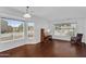 Bright, airy living room features large windows, hardwood flooring and a bay window nook, ideal for relaxation at 941 E Stirrup Ln, San Tan Valley, AZ 85143