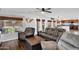 Open concept living room with dark wood flooring, comfortable seating, and view to backyard at 941 E Stirrup Ln, San Tan Valley, AZ 85143