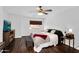 Spacious primary bedroom boasts wood floors, a window, and a ceiling fan at 941 E Stirrup Ln, San Tan Valley, AZ 85143