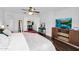 Large primary bedroom featuring wood floors, TV, and access to an adjacent room at 941 E Stirrup Ln, San Tan Valley, AZ 85143
