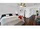 Bright primary bedroom features wood flooring and an ensuite bath with soaking tub at 941 E Stirrup Ln, San Tan Valley, AZ 85143