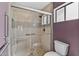 A renovated bathroom features a glass-enclosed shower, accessible features, and attractive tile work at 9839 W Utopia Rd, Peoria, AZ 85382