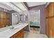 Bathroom with long countertop, double mirror, and wood cabinets at 9839 W Utopia Rd, Peoria, AZ 85382