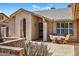 Charming single story home featuring desert landscaping and a beautiful wrought iron door at 9839 W Utopia Rd, Peoria, AZ 85382