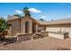 Charming single story home featuring desert landscaping and a beautiful wrought iron door at 9839 W Utopia Rd, Peoria, AZ 85382