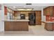 Kitchen with tile flooring, wood cabinets, and black appliances at 9839 W Utopia Rd, Peoria, AZ 85382
