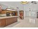 Kitchen featuring wooden cabinets, tile flooring, an island, and black appliances at 9839 W Utopia Rd, Peoria, AZ 85382