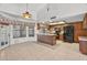 Kitchen featuring wooden cabinets, tile flooring, and an open view to the living room at 9839 W Utopia Rd, Peoria, AZ 85382