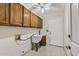 Laundry room with cabinets, utility sink, and white walls at 9839 W Utopia Rd, Peoria, AZ 85382