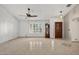 Bright living room featuring neutral paint, tile floors, large windows, and a grandfather clock at 9839 W Utopia Rd, Peoria, AZ 85382